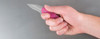 KERSHAW 1600PINK CHIVE SPEEDSAFE ASSISTED FOLDER. 1.9" PLAIN EDGE 420HC BLADE. 6061-T6 PINK ANODIZED ALUMINUM HANDLE. SHOWN IN HAND. CUTLERY SHOPPE