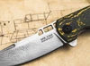 BOKER PLUS 01BO909DAM ME 109 DAMST FOLDER. 3.15" DAMASCUS CLIP POINT BLADE. TOXIC STORM FATCARBON & TITANIUM FRAMELOCK HANDLE. BLADE OBVERSE CLOSEUP. CUTLERY SHOPPE