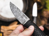 BOKER SOLINGEN 121505 BRONCO MINI BUSHCRAFT. 3.5" 80CrV2 BLACK STONEWASH BLADE. TEXTURED BLACK TPE HANDLE. BLACK KYDEX BELT SHEATH W/ULTICLIP. CLOSEUP SHOWN. CUTLERY SHOPPE