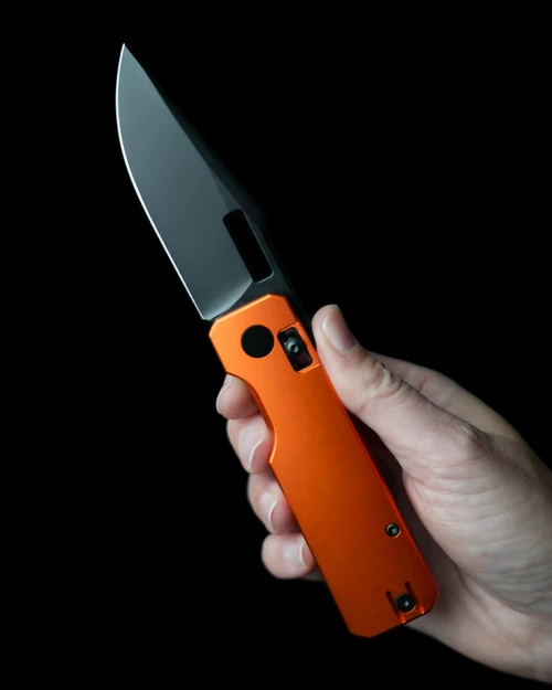 Vero Engineering AURA CrossBar Lock Front Flipper - 3.3" Black DLC Finish Sandvik 14C28N Blade - Orange Anodized Aluminum Handle - BLK-ORG-DP-002 SHOWN IN HAND - CUTLERY SHOPPE