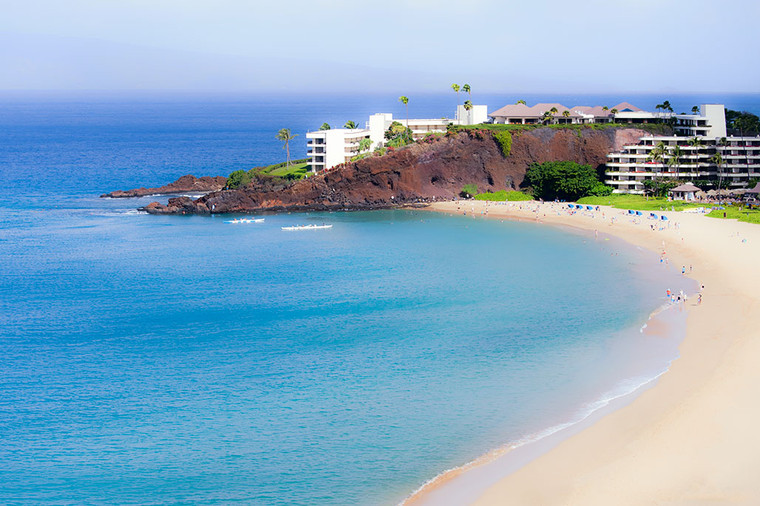 Aerial view of Ka'anapali Beach in Maui, Hawaii. Black Rock lava outcropping jutting into the blue turquoise ocean waters.