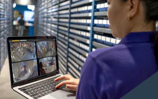 Person with laptop in a stock room
