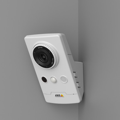Axis M1065-LW viewed from the side, and also showing its wall-mount bracket mounted to a wall