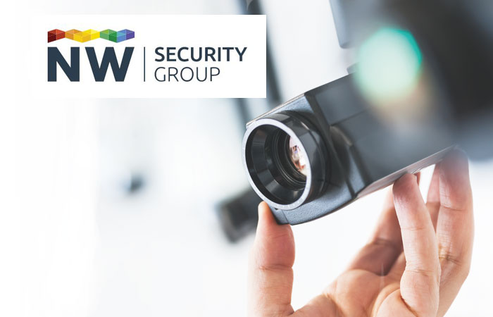 NW Security Group logo and a hand holding an IP camera as if to position it.