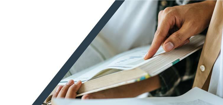 Hand pointing to the page of a book