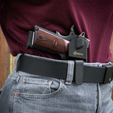 A woman wears her 1911 pistol IWB in a black GRITR OMNI Holster for secure and comfortable concealed carry