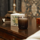 Shield scented candle on nightstand, lit