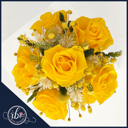 Preserved yellow roses in a bright smiley face vase, creating a cheerful floral display. Crafted by Ritzy Blooms in Fort Lauderdale