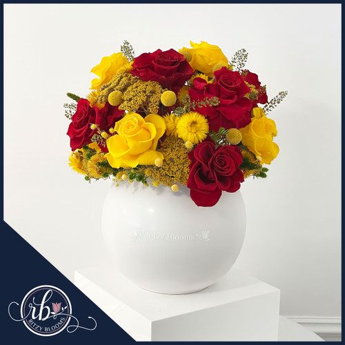 Golden Scarlet Splendor preserved floral arrangement by Ritzy Blooms, featuring vibrant red and yellow roses with golden accents in a sleek white vase, perfect for home decor or gifting in Fort Lauderdale, FL.