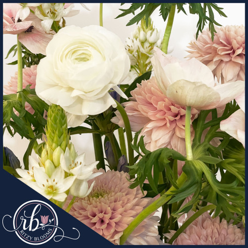 Blushing Meadow Flower Arrangement featuring pastel anemones, ranunculus, mums, and lush greenery in a modern white ceramic vase, designed by Ritzy Blooms in Fort Lauderdale. Blushing Meadow Flower Arrangement featuring pastel anemones, ranunculus, mums, and lush greenery in a modern white ceramic vase, designed by Ritzy Blooms in Fort Lauderdale.
