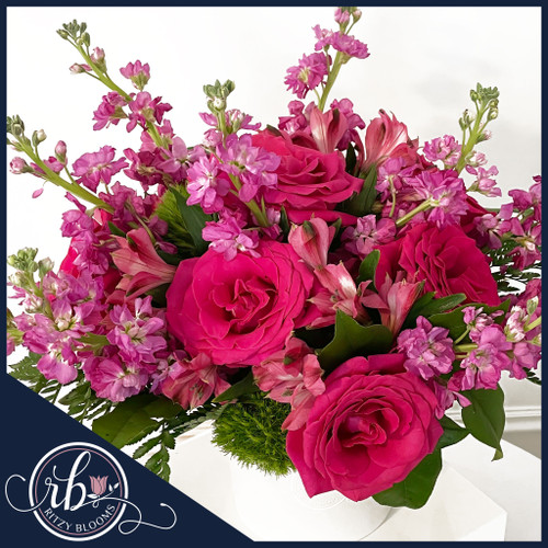 Hot pink roses, stock, and alstroemeria flower arrangement in white hat box by Ritzy Blooms Fort Lauderdale