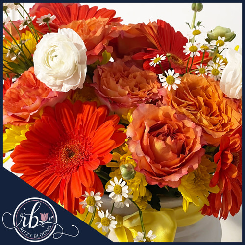 Sun-Kissed Delight flower arrangement with orange gerberas, yellow mums, roses, and daisies in a white vase with yellow ribbon – Fort Lauderdale florist
