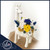 Preserved flower arrangement in a white ceramic giraffe, featuring blue blooms, designed and made in Fort Lauderdale by Ritzy Blooms.