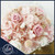 Petite blush preserved flower arrangement in a white ceramic turtle vase, handcrafted by a Fort Lauderdale florist for bedroom and nursery decor.