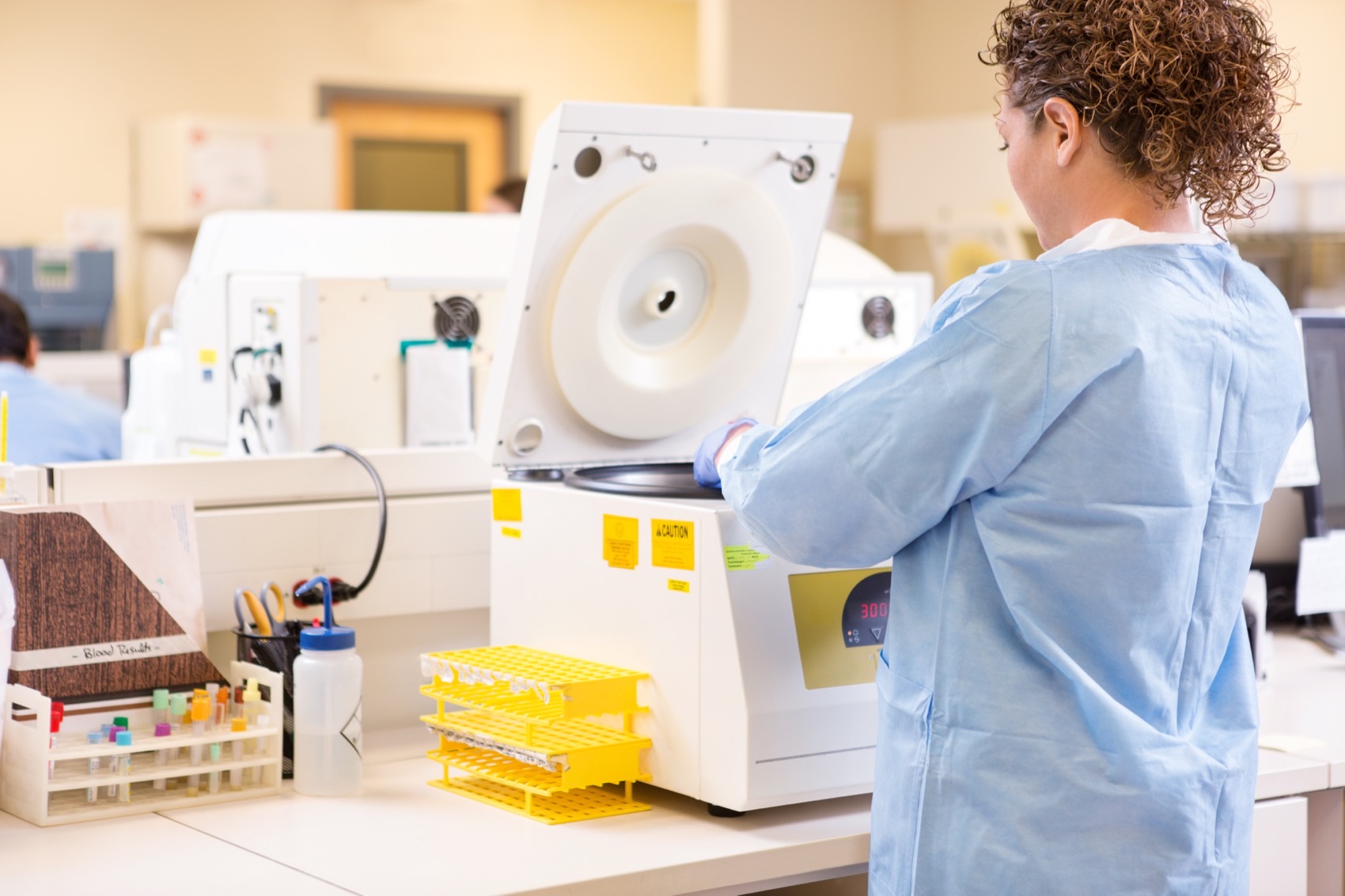 Biomedical engineer performing maintenance on lab equipment