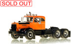 1:50 scale model of a 1954 Autocar DC-100T Tandem Axle Integral Sleeper - Orange over Black