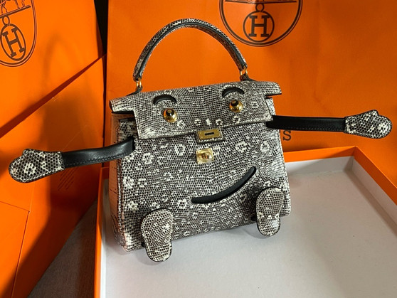 Hermes Kelly Idole (Kelly Doll) in Lizard with Gold hardware.
