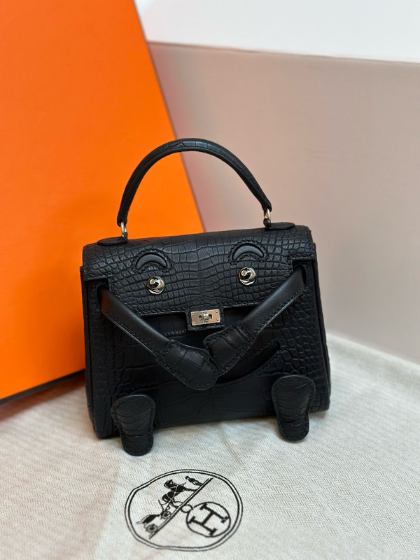 Hermes Kelly Idole (Kelly Doll) in Black Alligator with Palladium hardware.
