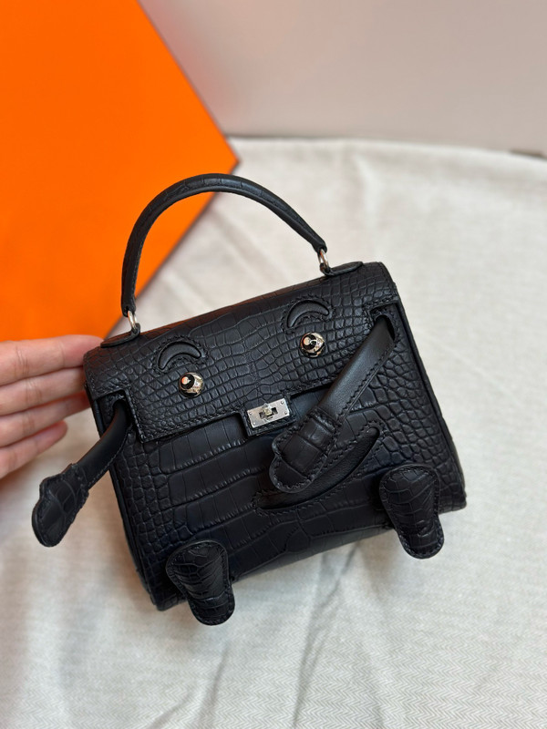 Hermes Kelly Idole (Kelly Doll) in Black Alligator with Palladium hardware.