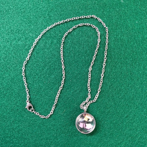 Stainless steel and glass locket on a stainless steel chain.  The locket holds memorial flowers.