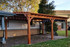 14x22 Arched Cedar Pergola Kit, Cedar color stain, Lattice Roof, Shade Master Retractable Canopy Burgundy B&W, Brighton, CO.