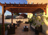 Backyard transformation with wall mounted pergola and stone pavers