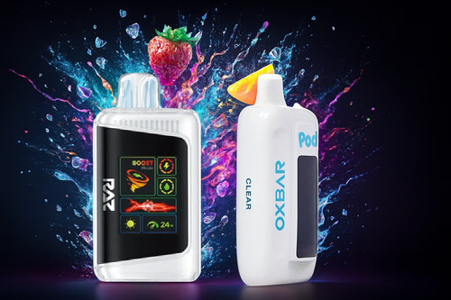 The photo shows two vape devices set against a lively, colorful background with splashes of liquid, ice cubes, and a strawberry. On the left is a transparent device labeled &ldquo;RAZ,&rdquo; featuring a digital display with icons and the text &ldquo;BOOST Mode&rdquo; showing 24W power. On the right is a sleek device marked &ldquo;OXBAR CLEAR Pod,&rdquo; topped with a yellow-orange mouthpiece. The vibrant backdrop emphasizes fruity flavors and a refreshing vibe, highlighting the products&rsquo; modern design and cool sensation.