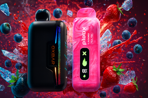 The photo shows two colorful vape devices placed side by side against a vibrant background of splashing fruit and ice. The device on the left is sleek and black with a rainbow-colored strip, labeled “OXBAR.” The device on the right is bright pink with a swirling pattern, marked “plobx” and “JUCOOLER PINK JAMBO,” featuring a display with icons such as a flame, a droplet, and “100%.” Surrounding them are strawberries, blueberries, and shards of ice, creating a lively, refreshing scene that emphasizes fruity flavors and bold design.