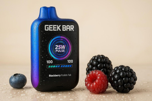 The image shows a Geek Bar vape device placed on a sandy beach. The device emits vapor and features a display reading "25W PULSE," surrounded by a circular graphic. Below the display, a color bar with the number "100" on both ends adds a dynamic touch. Nearby three raspberries lie on the sand, emphasizing the fruity theme.