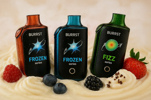 Three "BURRST" brand vape devices are nestled in a creamy, swirled substance, possibly yogurt or cream, alongside various berries. The devices, in orange, blue, and green, are from the "FROZEN series" and "FIZZ series." The arrangement highlights the sweet and dessert-like nature of the flavors.