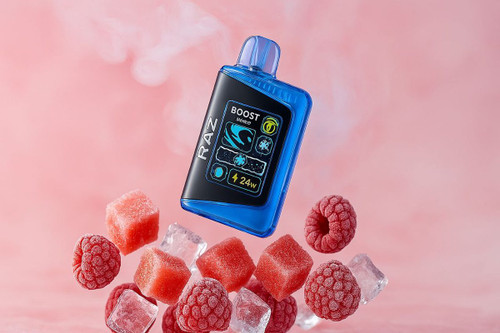 The image shows a disposable vape with ice cubes, watermelon cubes and frosty raspberries around it. There is light smoke in the background.