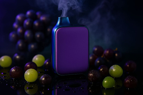 A prominent purple and blue vaping device stands upright, emitting white vapor against a dark, moody background. Surrounding the vape are various grapes, both dark purple and light green, many appearing wet with scattered water droplets on the reflective surface. In the background, out of focus, are larger clusters of dark grapes, reinforcing the fruity, grape-flavored theme.