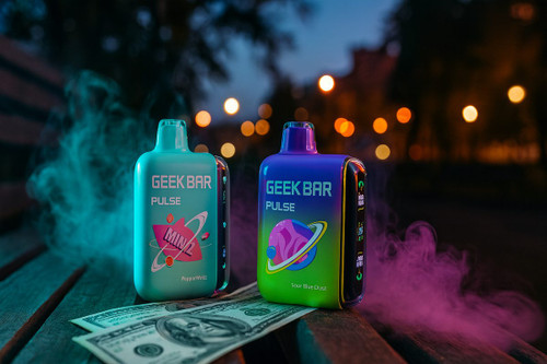 Two Geek Bar Pulse disposable vapes, one teal and one purple-to-green gradient, sit on a wooden park bench next to scattered US dollar bills. Colorful smoke swirls around the devices against a dark, bokeh-lit background of city lights at night. The vapes feature vibrant planetary graphics and digital side displays illuminated with small icons.