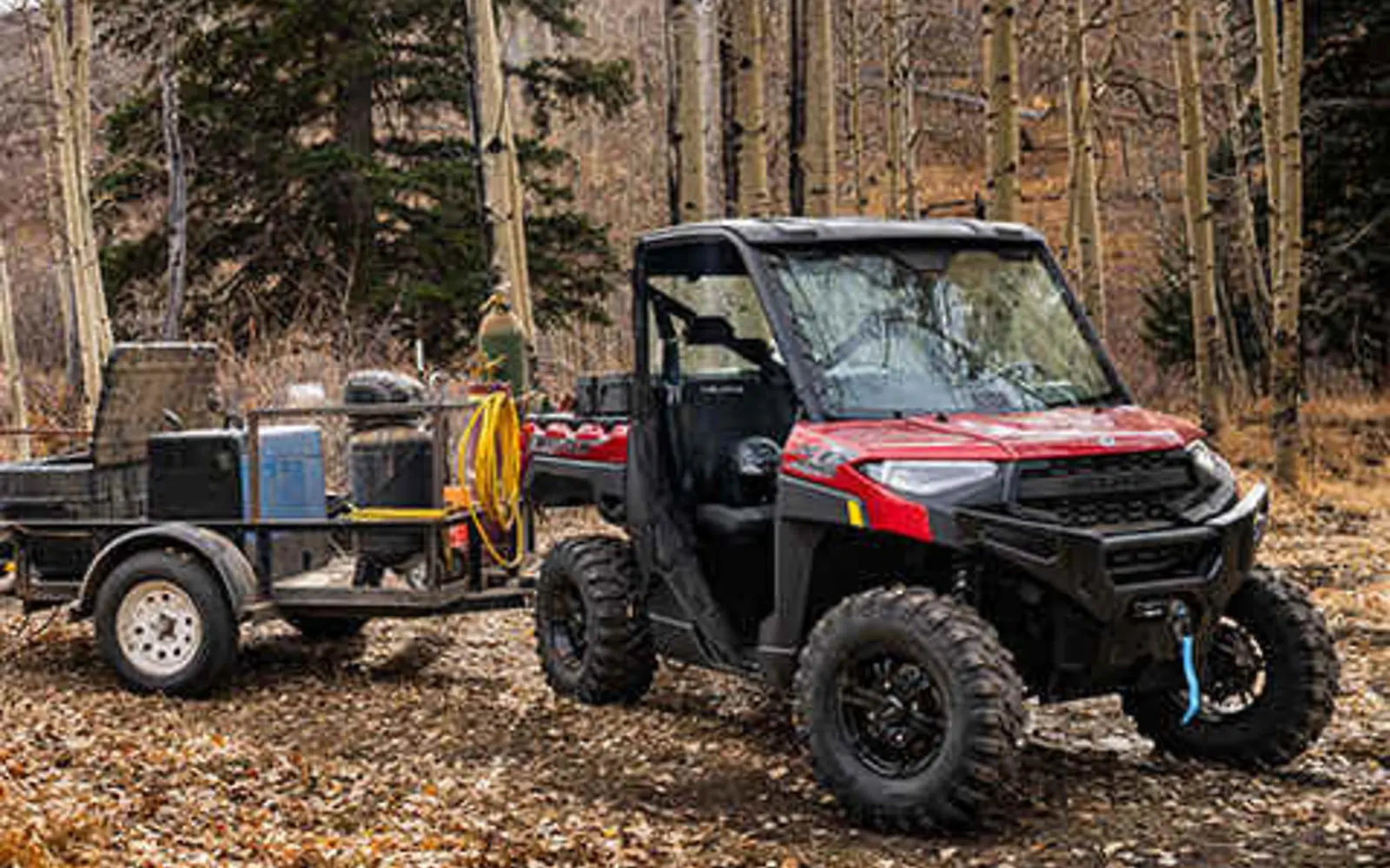 Red 2026 Polaris Ranger XP 1000 utility side-by-side working in the woods