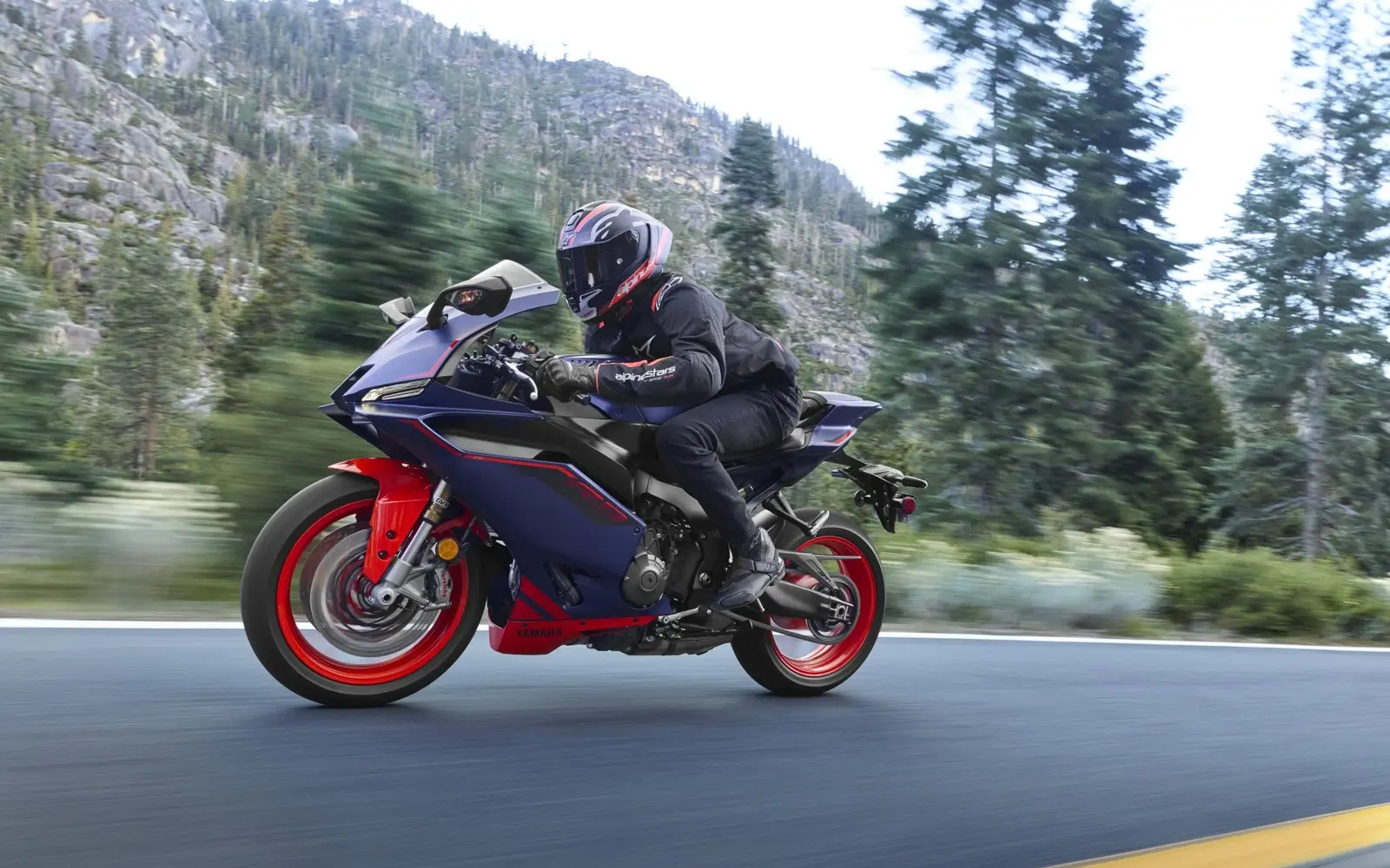 2027 Yamaha YZF-R9 sport motorcycle riding on a mountain road
