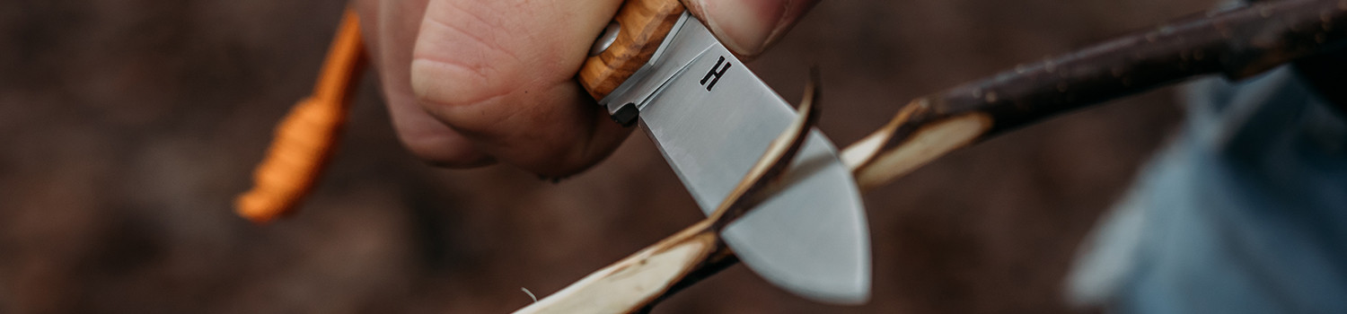 The Man Using Whetstone To Sharpening His Pocket Knife. Pocket