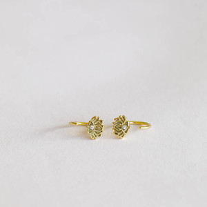Our dainty Lotus Flower Huggies will stand out from the rest and are perfect for everyday wear. Loop these through and let this pair "hug" your ears tight. Featuring a petite CZ stone cut into shape and set in an 18k gold-plated huggie earring over sterling silver.