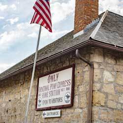 Pony Express sign on stone building