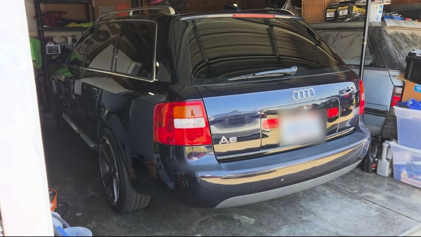 Dark Audi wagon in a garage with glossy paint