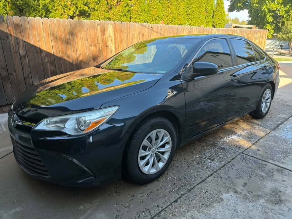 Black Toyota Camry, freshly washed and sealed