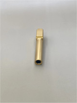 Front‑facing view of a Gold TiN‑coated Glock 19 Gen 1-5 barrel positioned upright on a light‑colored surface, showing the muzzle opening and clean finish.

Front view of a Gold TiN 9mm pistol barrel against a light background.