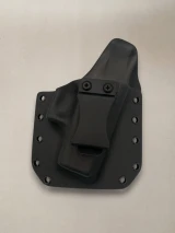 Black Kydex holster with belt clip attached and riveted edges, shown from the front on a neutral background.

Black Kydex holster for Glock 43/43X with adjustable cant, IWB/OWB compatible, made in USA.