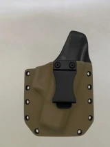 FDE Kydex holster with belt clip attached and riveted edges, shown from the front on a neutral background.

FDE Kydex holster for Glock 19 Gen 1-5 with adjustable cant, IWB/OWB compatible, made in USA.