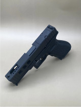 Side profile of the Kineti-Tech LWP Complete Slide for Glock® 17 Gen 5 showcasing its aggressive porting, deep rear serrations, and CERAKOTE® Armor Black finish. Includes RMSc footprint optic cut and 6‑port stainless steel barrel designed to minimize recoil.

Side view Armor Black LWP Kineti-Tech Slide for Glock 17 Gen 5 with deep serrations.