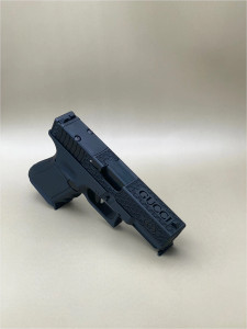 Angled view of the Kineti-Tech Gucci Complete Slide for Glock® 19 Gen 3, finished in Armor Black CERAKOTE®, showing the precision‑machined slide cuts and lightweight 12oz design. The stainless steel barrel and RMSc® optic‑ready cut are visible, highlighting the slide’s aggressive styling and performance-focused features.

Kineti-Tech Gucci Complete Slide for Glock 19 Gen 3 in Armor Black shown at an angle with optic cut and slide cuts.