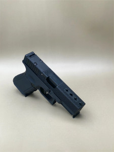 Angled view of the Kineti-Tech Louis Vuitton Complete Slide for Glock® 19 Gen 3, finished in Armor Black CERAKOTE®. The custom milled engraving and precision‑machined slide cuts are visible, along with the RMR® optic‑ready footprint and stainless steel barrel, highlighting the slide’s premium style and aggressive performance design.

Angled view of Kineti-Tech Louis Vuitton Glock 19 Gen 3 slide with custom engraving and RMR optic cut.