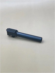 An angled photograph of a 9mm pistol barrel made from DLC‑coated 416R stainless steel, displayed on a neutral background to highlight its flush‑cut profile and exterior finish.

Angled view of a DLC‑coated Glock 17 Gen 5 standard barrel on a light background.