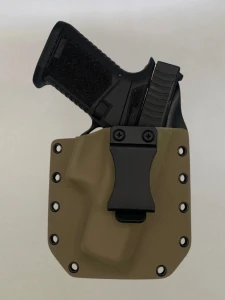Black Glock pistol inserted into a FDE Kydex holster with belt clip, demonstrating fit and retention.

FDE Kydex holster for Glock 19 Gen 1-5 with forward cant, fits most Glock slides for IWB or OWB carry.