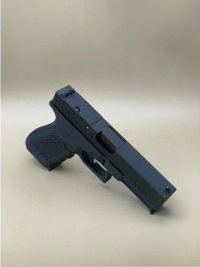 Close-up angled view of the Kineti-Tech Serrated Beveled Complete Slide installed on a Glock® 17 Gen 3 frame in Armor Black CERAKOTE® finish. The slide features deep-cut front and rear serrations for enhanced grip and a rear optic cut compatible with Trijicon® RMR® footprint optics. The firearm is positioned on a neutral beige background for clear product visibility.

Kineti-Tech Serrated Beveled Complete Slide for Glock 17 Gen 3 in Armor Black CERAKOTE® finish with optic cut and serrations.