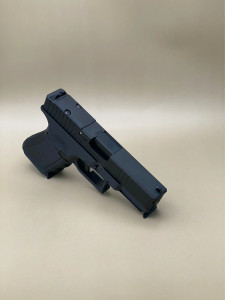 A left-side profile of the Kineti-Tech Serrated Bullnose Complete Slide mounted on a Glock® 45 Gen 5 frame. The Armor Black CERAKOTE® finish is clearly visible, along with deep-cut front and rear serrations. The slide is shown against a neutral background, emphasizing its rugged design and optic-ready rear cut.

Left-side view of Kineti-Tech Serrated Bullnose Slide for Glock 45 Gen 5 with deep serrations and black CERAKOTE® finish.